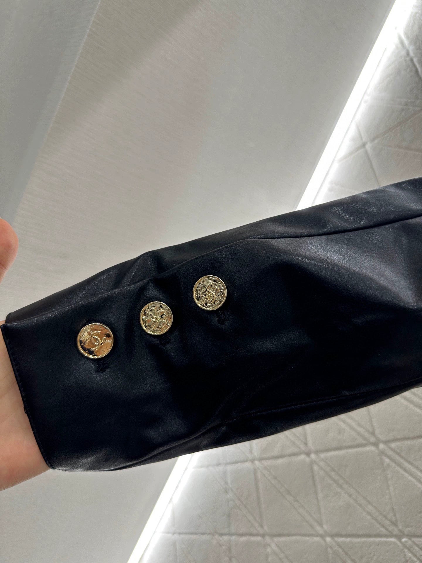 C 25 Mid-length leather trench coat.
