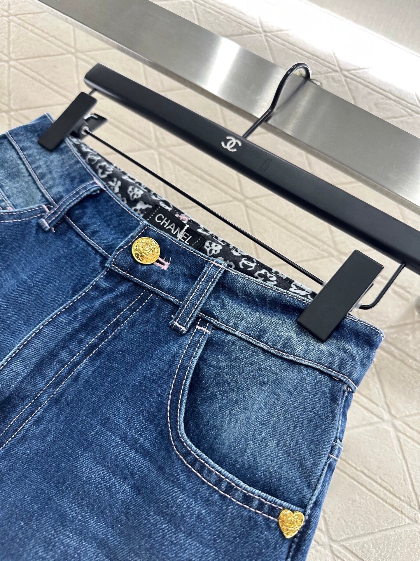 C 25 High-waisted bleached pleated denim trousers