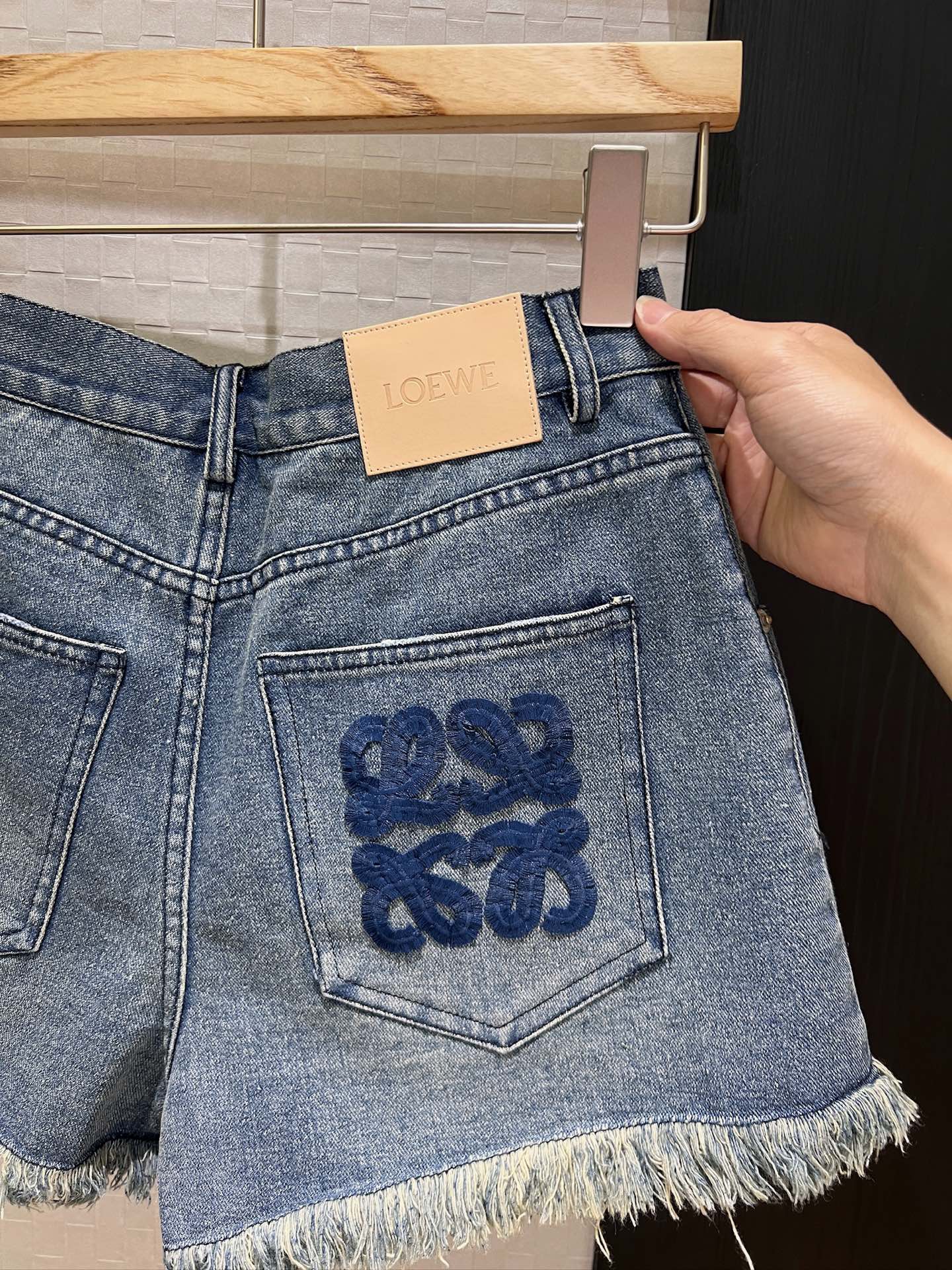 LO 25 Raw-edge fringe denim shorts