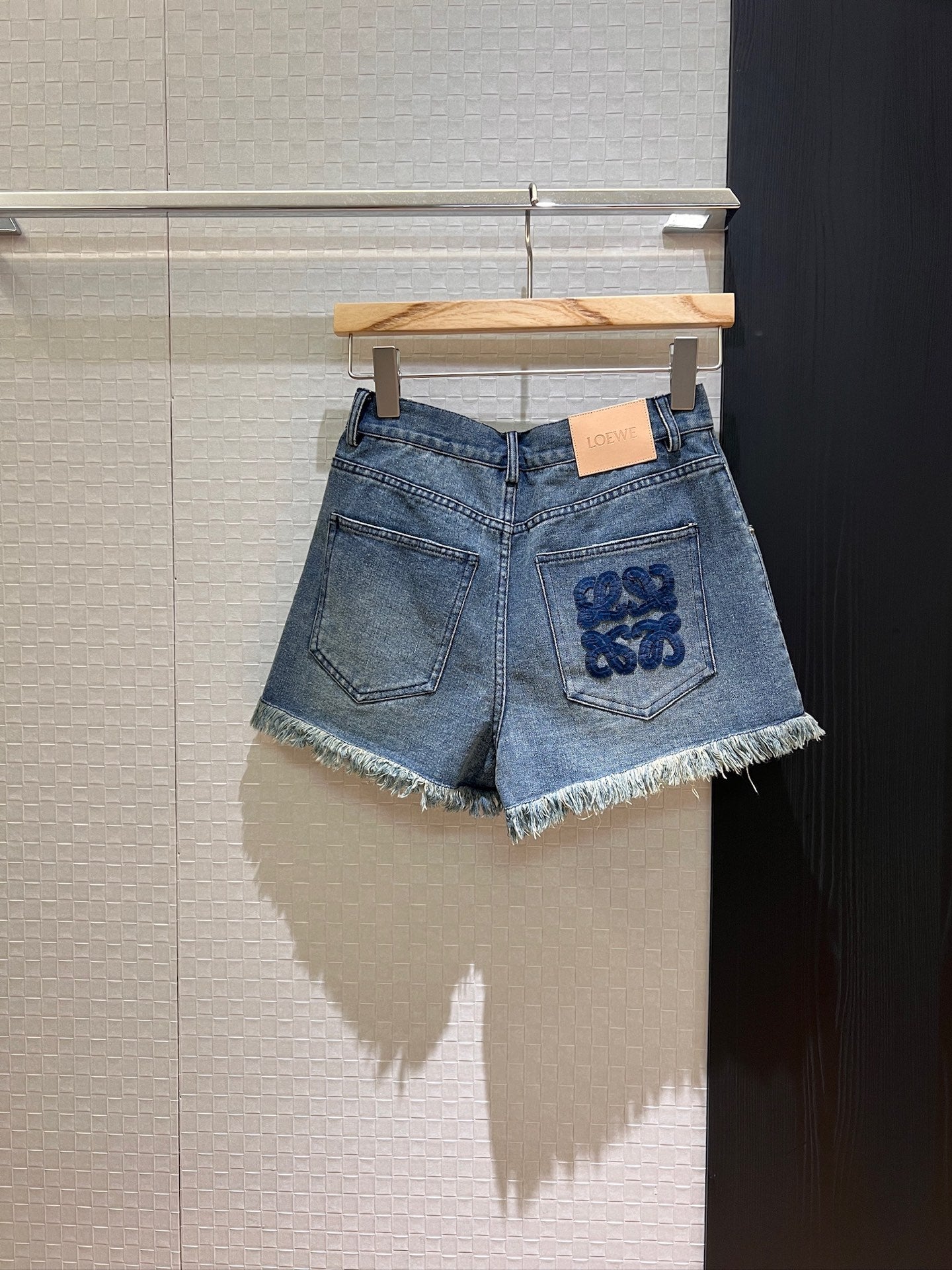 LO 25 Raw-edge fringe denim shorts