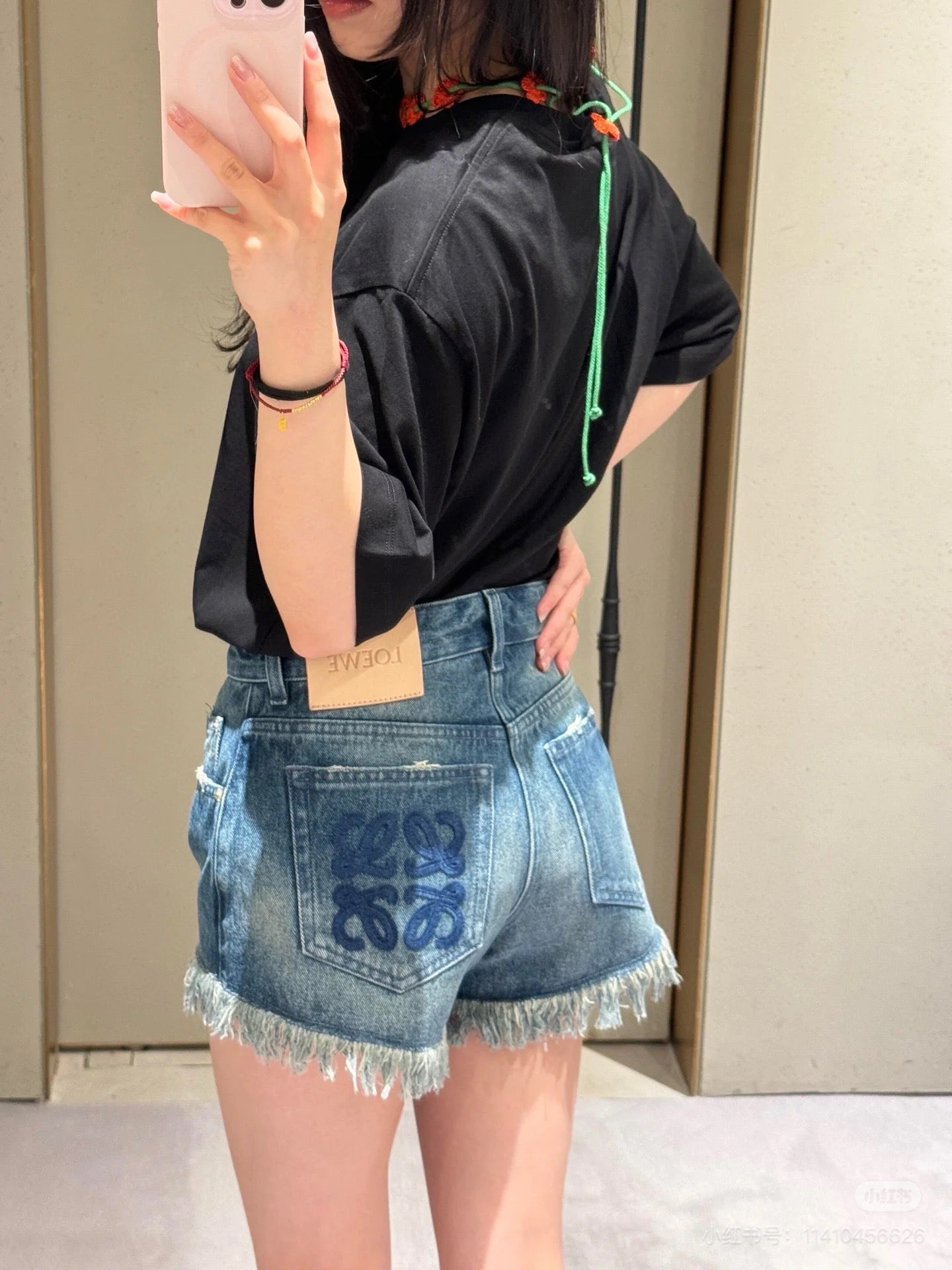 LO 25 Raw-edge fringe denim shorts