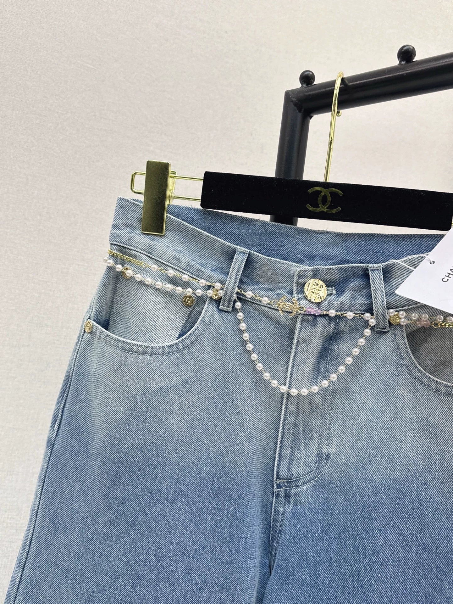 C 25 New early fall wide-leg jeans with a metal waist chain.