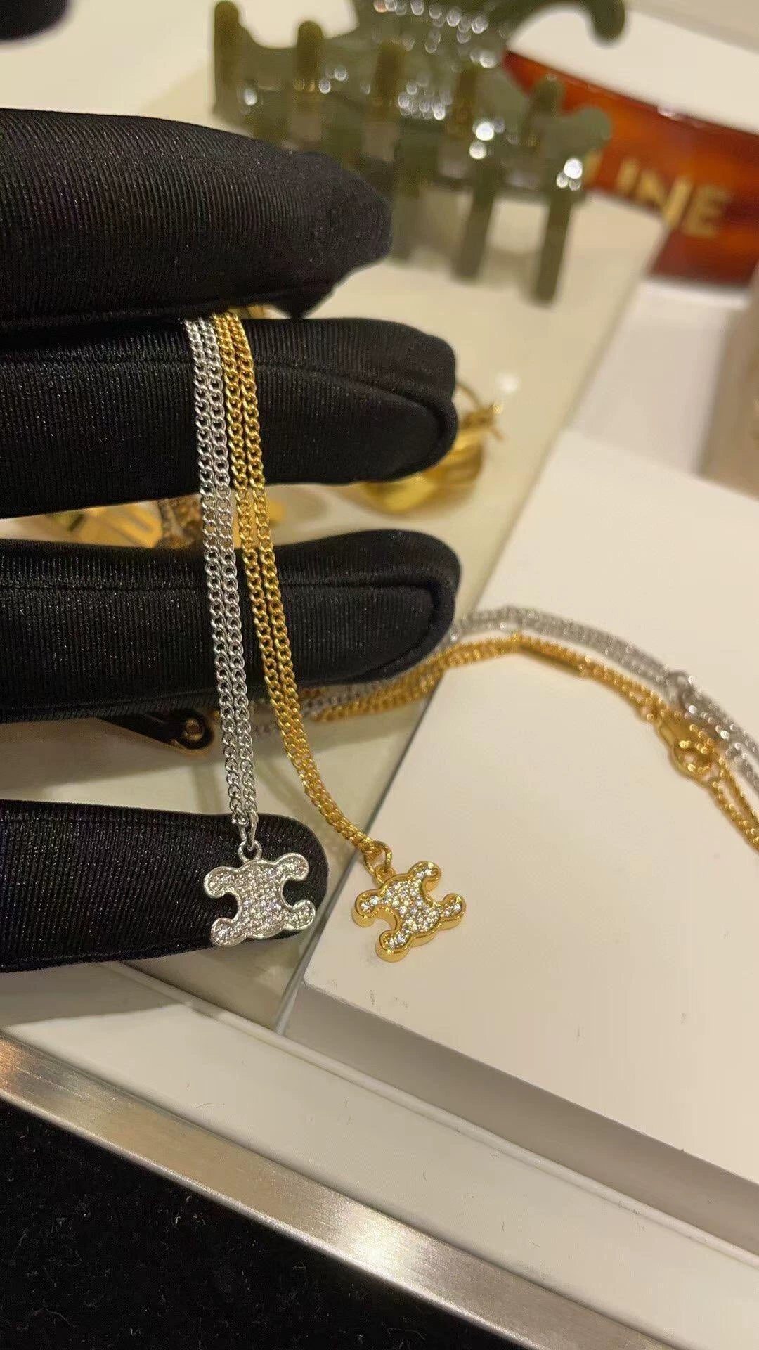 CE 25 Gold necklace with full diamond logo and Arc de Triomphe logo