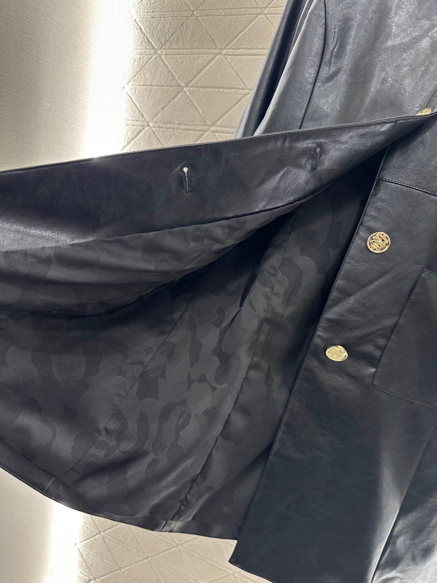 C 25 Mid-length leather trench coat.