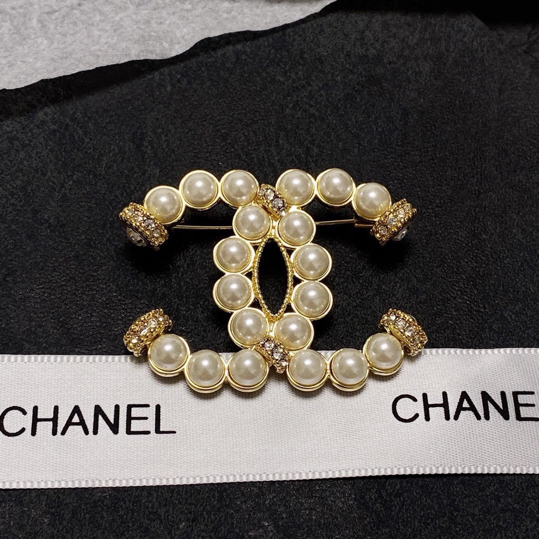 C 25 Pearl logo brooch