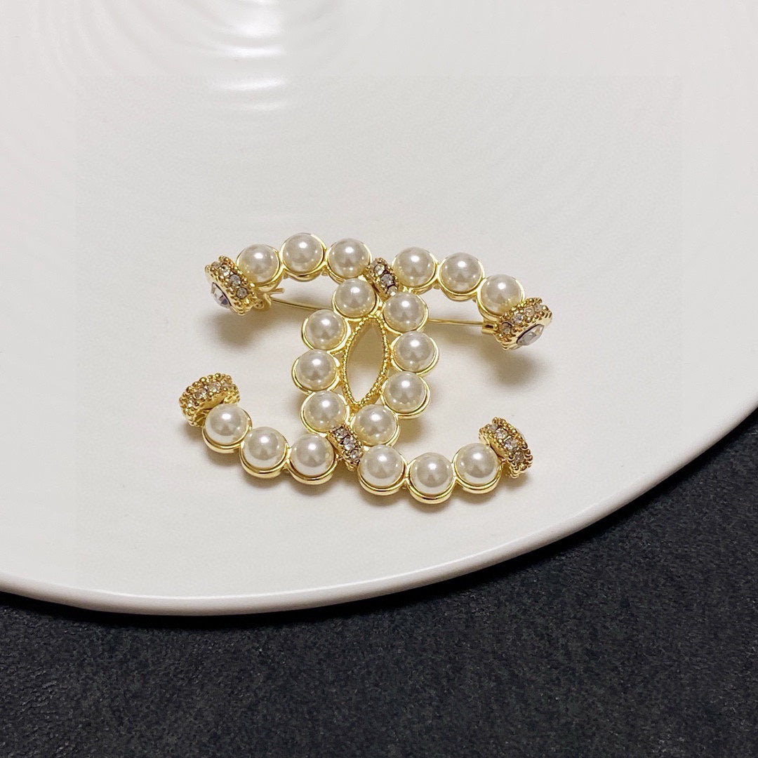 C 25 Pearl logo brooch