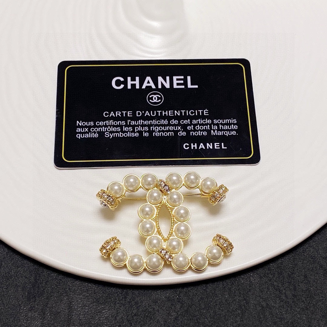C 25 Pearl logo brooch