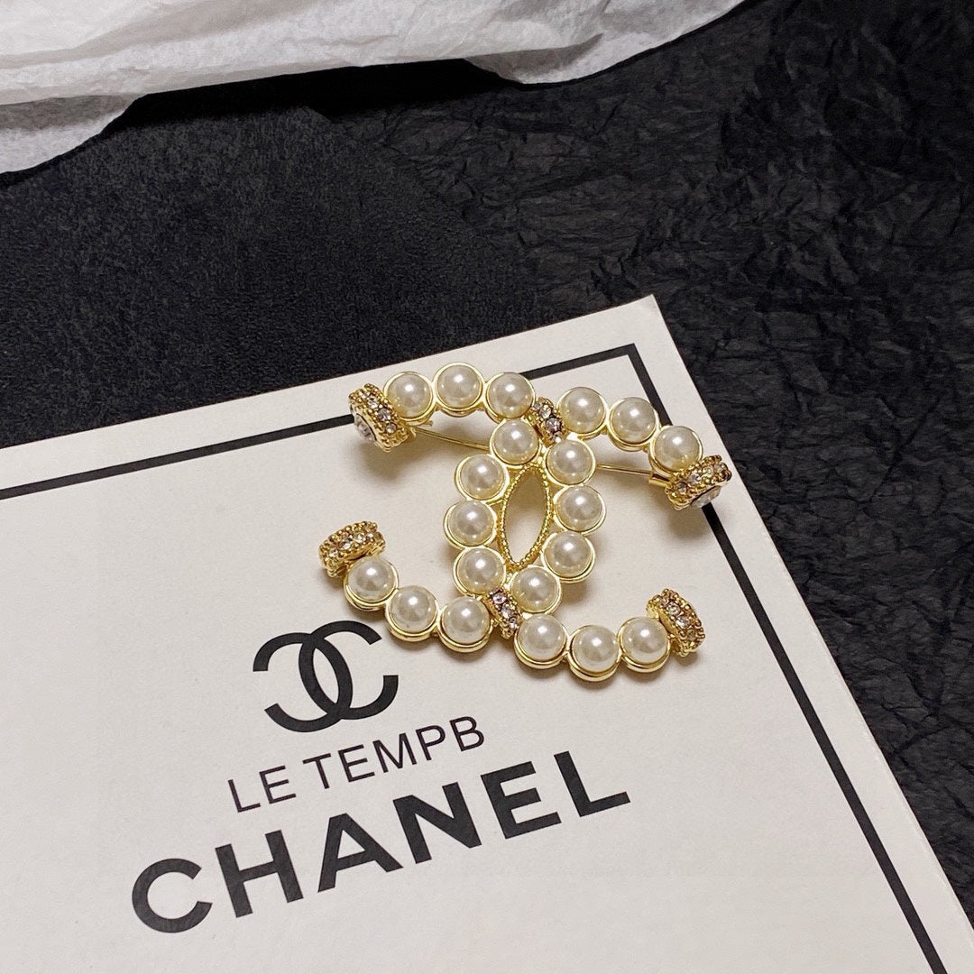 C 25 Pearl logo brooch