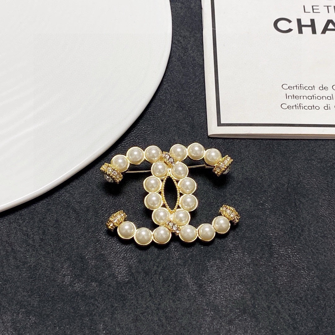 C 25 Pearl logo brooch