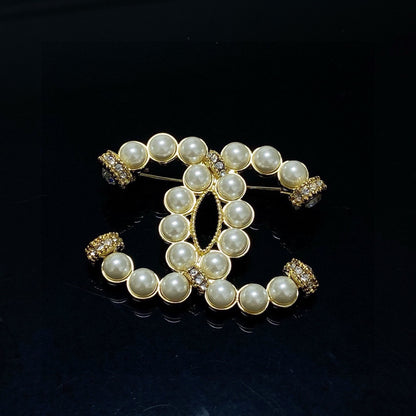 C 25 Pearl logo brooch