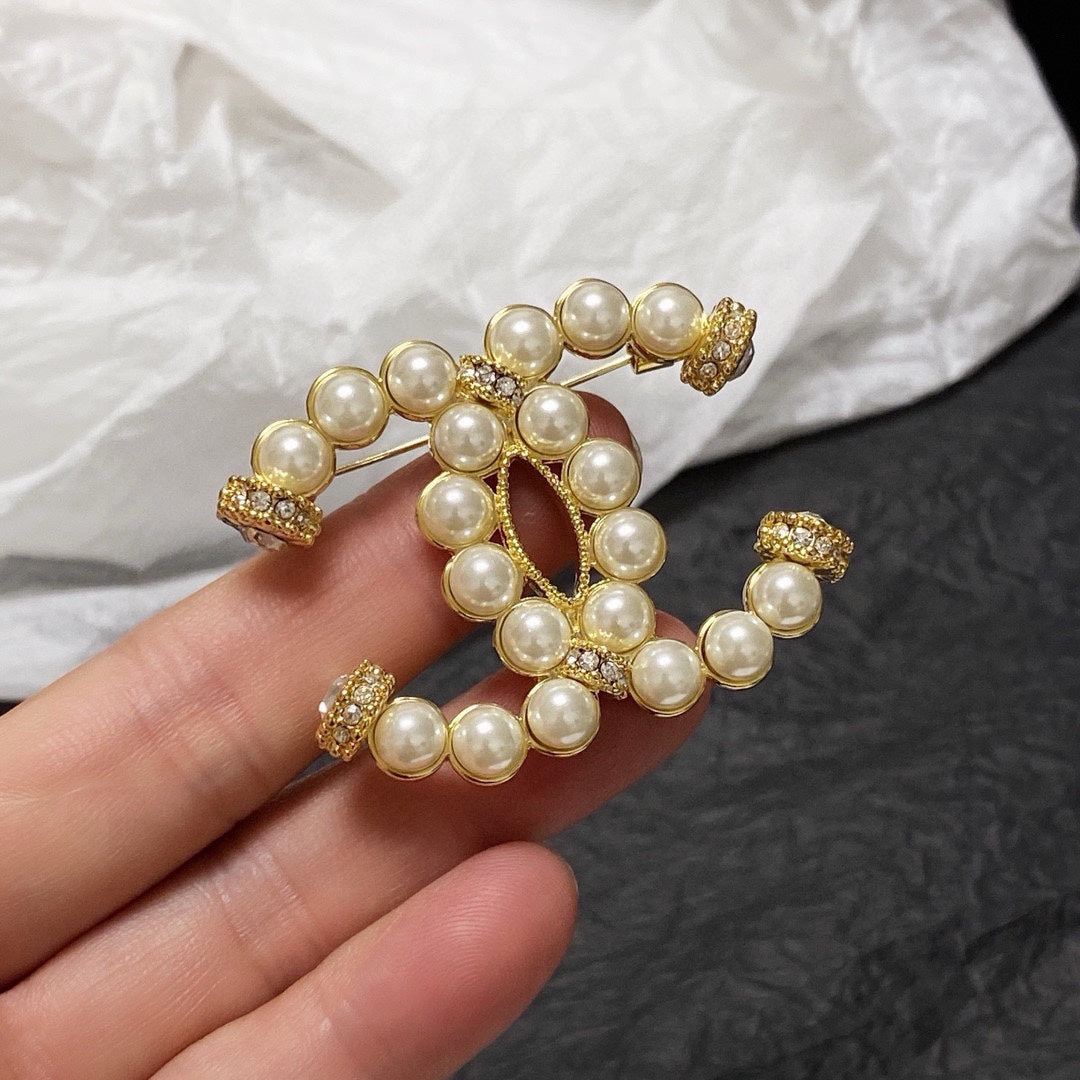 C 25 Pearl logo brooch
